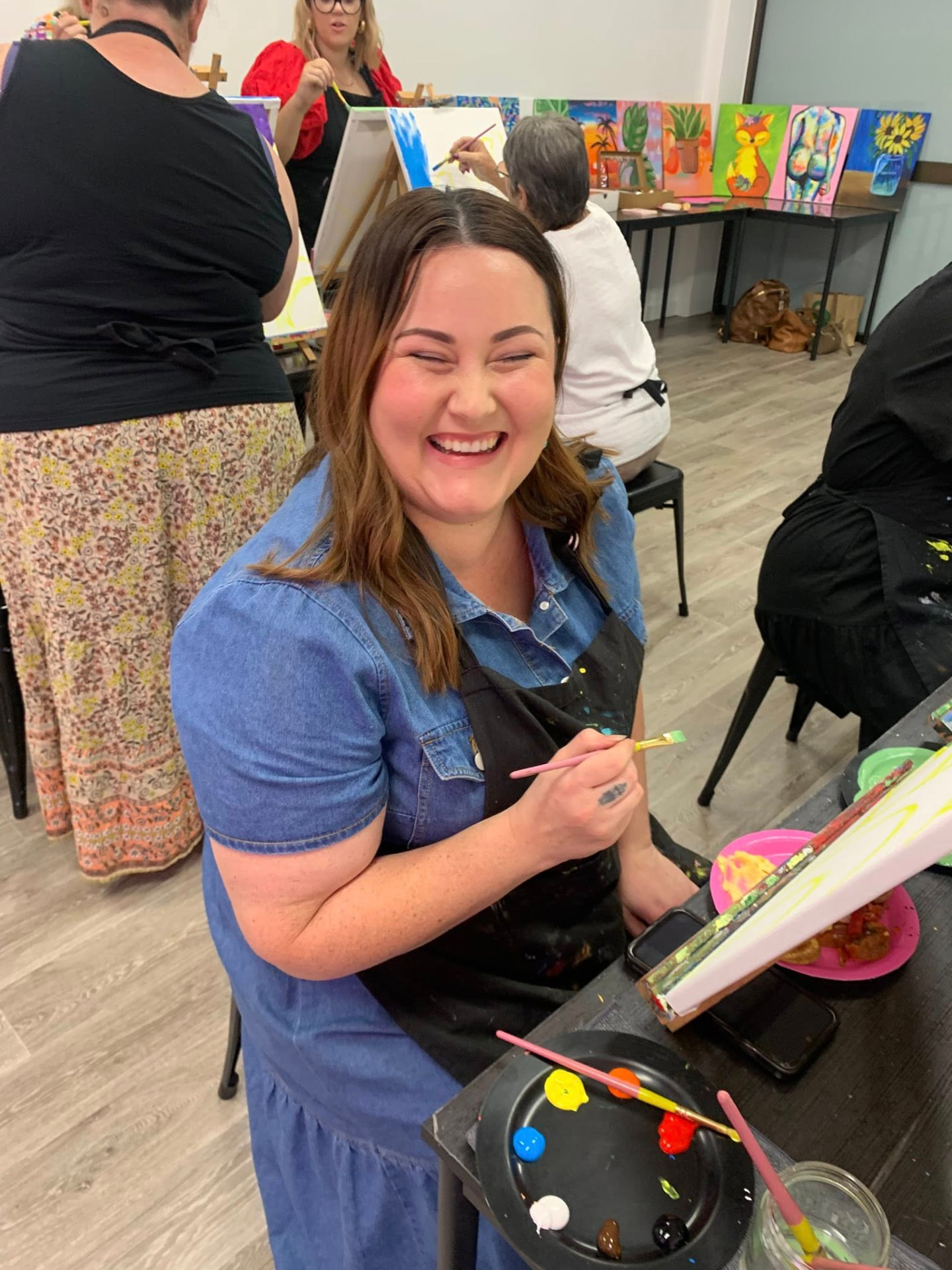 Happy guest painting at The Social Canvas studio